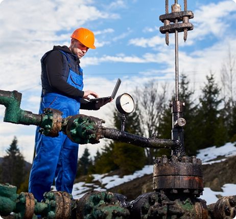 petroleum-engineer-using-laptop-oil-field